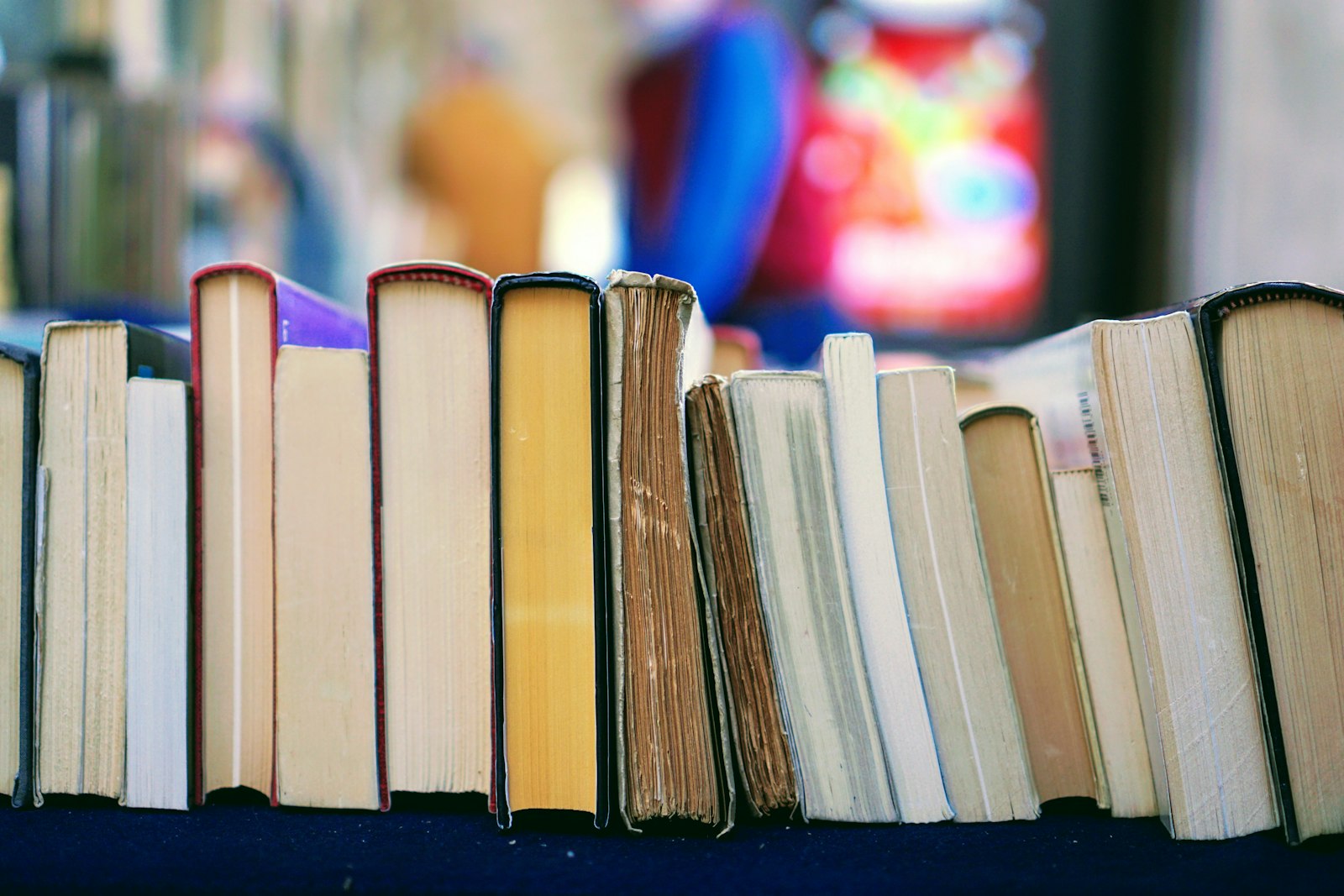 Row of well-worn books on a shelf
